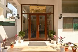 a front door of a building with potted plants at peaceful studio in Navi Mumbai