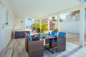 a dining room with a table and chairs at 6BR & 6BA 5 Mins to Beach at Alegria Villa by Bocobay in Palm-Eagle Beach