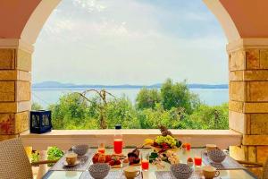 a table with food and a view of the water at NISSAKI SUNLIGHT by Sealand Villas in Nisakion