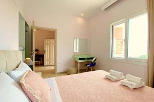 a bedroom with a bed and a desk in it at NISSAKI SUNLIGHT by Sealand Villas in Nisakion +20 photos