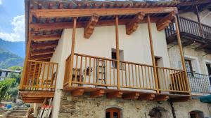 a building with wooden balconies on the side of it at ViviMontagna Livienne in Perosa Argentina