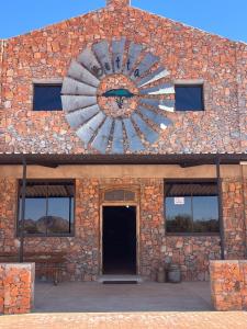 a brick building with a large wheel on it at Betta Lodge in Maltahöhe