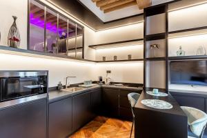 a kitchen with stainless steel cabinets and a sink at SWEET LEONE II -appartement avec spa privé-Lyon Place Terreaux in Lyon