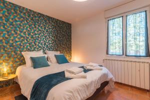a bedroom with a large white bed in a room at Domaine Plan Des Devens Quiétude in Roussillon +21 photos