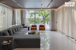 a living room with a couch and two chairs at StayVista at Casa Canto with Infinity Pool in Siolim