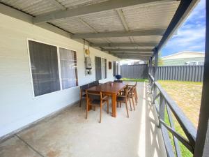 a patio with a table and chairs on a balcony at Sea Breeze in Lancelin