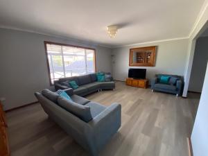 a living room with two couches and a television at Sea Breeze in Lancelin