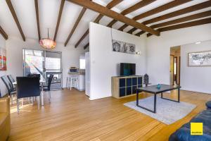 a living room with a table and a couch at Sea Gem in Lancelin +2 photos