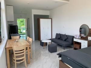 a living room with a couch and a table at Căn hộ studio view biển hoặc vườn in Ấp Phú Tịnh (2) +34 photos