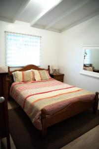a bedroom with a bed and a window at Seabliss in Lancelin
