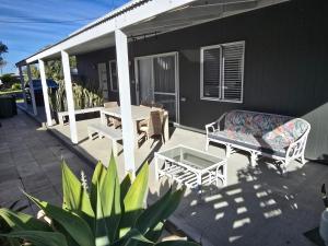 a patio with a table and chairs on a house at Sou Wester in Lancelin