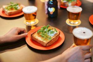a table with a plate of food and glasses of beer at Sendai FLAT 01 GORIN in Sendai