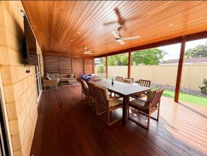 a wooden deck with a table and chairs at Things of Stone and Wood in Lancelin