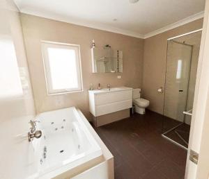 a bathroom with a tub and a sink and a toilet at Things of Stone and Wood in Lancelin +12 photos