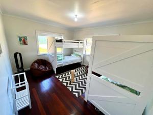 a room with two bunk beds in a room at Playgrounds in Lancelin