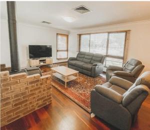 a living room with two couches and a fireplace at The Newby in Lancelin