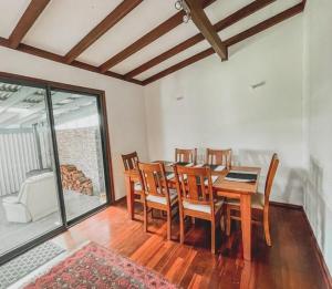 a dining room with a wooden table and chairs at The Newby in Lancelin
