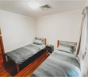 a bedroom with two beds in a room at The Newby in Lancelin +4 photos