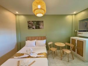 a small room with a bed and a table at ABC Homes PH in Olongapo