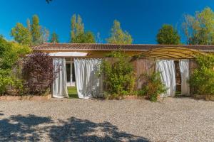 a building with white drapes on it at Domaine Plan Des Devens Volupté in Roussillon