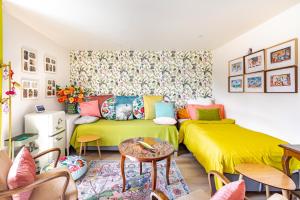 a living room with two beds and a couch at Maison 1934 - Colmar Gare & Parking gratuit in Colmar