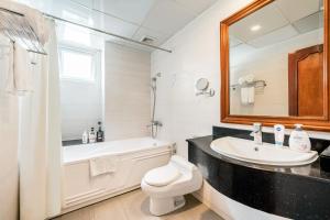 a bathroom with a sink and a tub and a toilet at A25 Hotel - 19 Phan Đình Phùng in Hanoi +28 photos