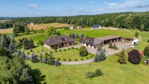 an aerial view of a large house on a green field at Rezydencja Mądrzechowo in Gersdorf