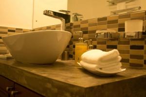 a bathroom counter with a sink and a towel at Deluxe 4BR Penthouse By Unique Towers in Colombo