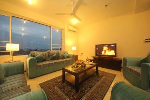 a living room with couches and a flat screen tv at Deluxe 4BR Penthouse By Unique Towers in Colombo