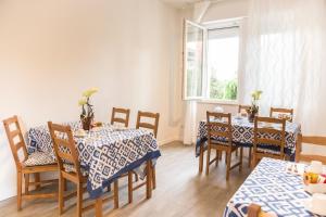 a dining room with tables and chairs and a window at B&B LA CORTE SANTA MARIA in Negrar +40 photos