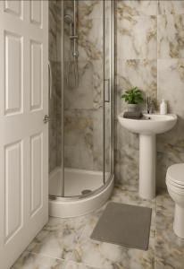 a bathroom with a shower and a toilet and a sink at Blossom Lets in Manchester +1 photo