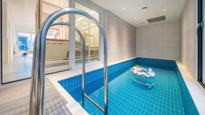 a bathroom with a pool with a toy car in it at Gapyeong Pinetree Kids Pool Villa in Gapyeong