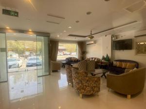 a living room with couches and chairs and a television at شقق درة حي الريان للشقق المخدومة DORAT HAY aL RAYAN FOR SERVICED APARTMENT in Riyadh