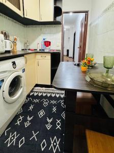 a kitchen with a washing machine in a kitchen at Международный Аэропорт Алматы Апартаменты "100 метров" in Almaty