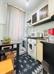 a kitchen with a washer and dryer in it at Международный Аэропорт Алматы Апартаменты "100 метров" in Almaty