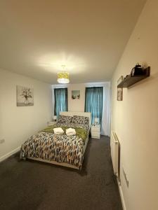 a bedroom with a bed and two windows at Comfy Premium Home in Town in Bracknell