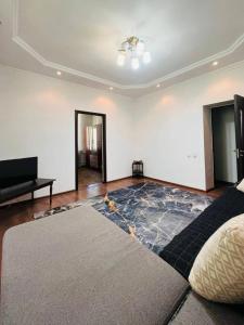 a living room with a large rug on the floor at Международный Аэропорт Алматы Апартаменты "100 метров" in Almaty +3 photos