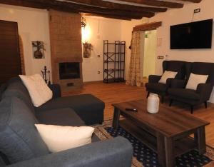 a living room with a couch and a coffee table at Casa Larralde in Bisimbre