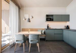 a kitchen and dining room with a table and chairs at Florerhof in Schenna +12 photos