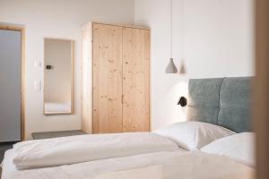 a bedroom with a bed and a wooden cabinet at Florerhof in Schenna
