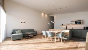 a kitchen and living room with a table and chairs at Florerhof in Schenna