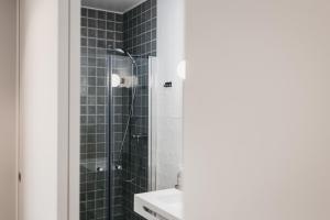 a bathroom with a shower and a sink at &Tales Suites - Óbidos in Óbidos