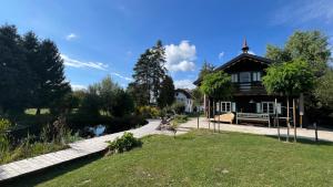 a house with a garden and a pond in front of it at Landhaus Danner in Goldwörth