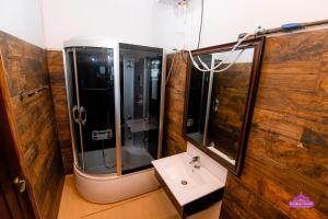 a bathroom with a shower and a sink in it at Prabhaz Grand in Hatton
