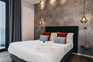 En eller flere senge i et værelse på &Tales Suites - Óbidos