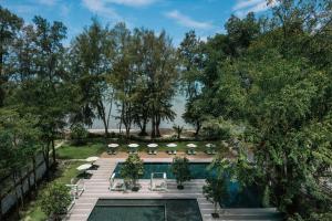 an overhead view of a pool with chairs and umbrellas at Lone Pine, Penang, a Tribute Portfolio Resort in Batu Ferringhi