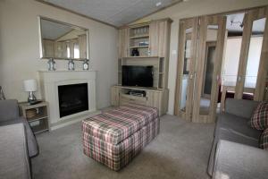 a living room with a couch and a television at Harbourside in Christchurch