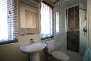 a bathroom with a sink and a toilet and a shower at Harbourside in Christchurch +13 photos
