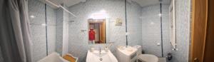 a bathroom with a sink and a toilet and a mirror at Apartamento Poblete in Poblete +23 photos