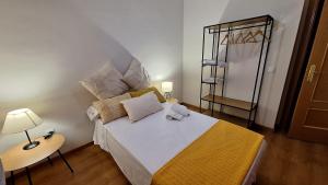 a bedroom with a large bed and a mirror at Apartamento Poblete in Poblete